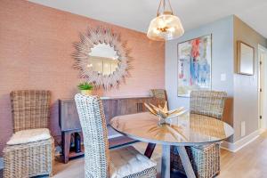 a dining room with a table and chairs and a mirror at Boho Bayshore 42 in Ocean City