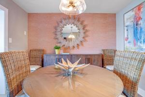 a dining room with a wooden table and a mirror at Boho Bayshore 42 in Ocean City