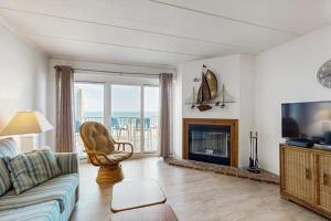 a living room with a couch and a fireplace at Purnell House 402 in Ocean City
