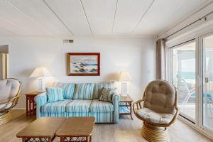 a living room with a couch and a chair at Purnell House 402 in Ocean City