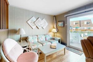 a living room with a couch and a table at Gullway Getaway in Ocean City