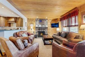 a living room with two couches and a fireplace at WeSeekANook in Meredith