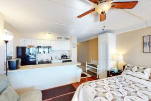 a bedroom with a bed and a ceiling fan at Atlantis 502 in Ocean City +6 photos