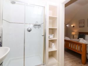 a bathroom with a shower and a sink at No 2 The Stables in Llangefni +27 photos