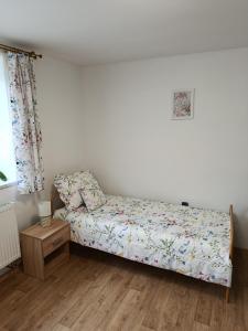 a small bedroom with a bed and a window at Chalupa u dědy in Kozlov