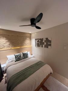 a bedroom with a bed with a ceiling fan at CHL Pod in General Trias