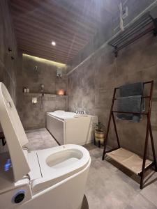 a bathroom with a toilet and a sink at CHL Pod in General Trias