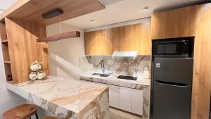 a kitchen with a marble counter top and a refrigerator at CHL Pod in General Trias +10 photos