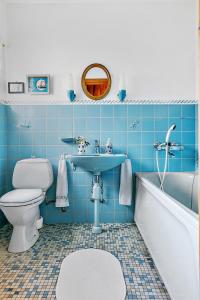 a bathroom with a sink and a toilet and a tub at Spacious Villa near Gothenburg in Alingsås +13 photos