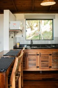 a kitchen with a sink and a window at Pousada Quinta do Cangueri in Imaruí +8 photos