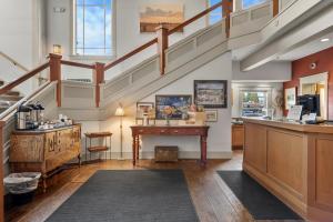a large room with a staircase and a table at Hotel McCall in McCall