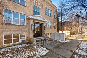 a brick building with a gate in front of it at Aisling Suites in Great Falls