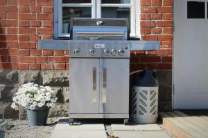 a barbecue grill sitting outside of a house at Villa Linnea in Hanko