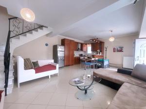a living room with a couch and a table at An-Mary by vacapers in Iraklitsa