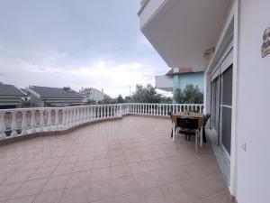 a balcony with a table and chairs on it at An-Mary by vacapers in Iraklitsa