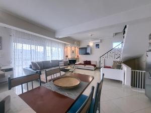 a living room with a table and a couch at An-Mary by vacapers in Iraklitsa
