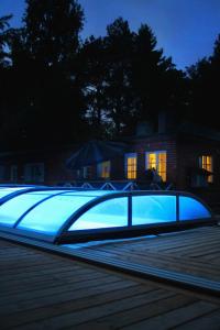a swimming pool lit up at night at Villa Linnea in Hanko