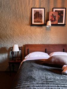 a bedroom with a bed with two lamps on the wall at Relais du Moulin - Bed & Breakfast in Abreschviller +17 photos