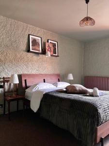 a bedroom with a large bed with two pillows at Relais du Moulin - Bed & Breakfast in Abreschviller