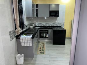 a kitchen with a sink and a stove at Rosebank Villas in Luanda +7 photos