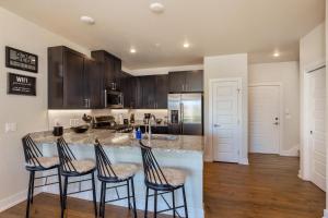 a kitchen with a counter with four bar stools at Sail Lofts #301 in Dillon +21 photos