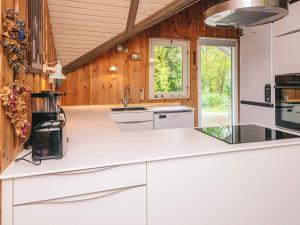 a kitchen with white counters and wooden walls at 6 person holiday home in Oksbøl in Oksbøl