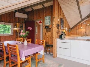 a kitchen and dining room with a table and chairs at 6 person holiday home in Oksbøl in Oksbøl +22 photos
