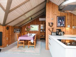 a kitchen and dining room with a table and chairs at 6 person holiday home in Oksbøl in Oksbøl