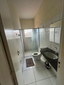 a bathroom with a toilet and a sink at Casa no pavimento superior in São Luís