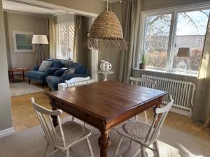 a living room with a wooden table and chairs at Villa Emma in Alsterbro