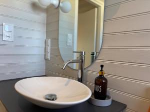 a bathroom with a sink with a bottle of wine at Villa Emma in Alsterbro