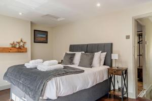 a bedroom with a large bed with two pillows at 2 Bed in Cherry Burton oc-c37535 in Cherry Burton
