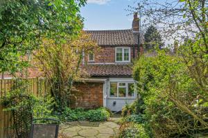 a brick house with a white door and a fence at 2 Bed in Cherry Burton oc-c37535 in Cherry Burton