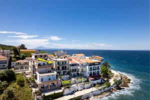 a group of houses on a hill next to the ocean at Sea U in Kalívia