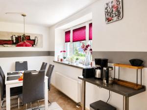 a kitchen with a table and a dining room at Ferienwohnung Saupe in Königshain