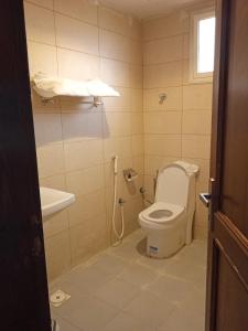 a bathroom with a toilet and a sink at الدغيثر للشقق المخدومه in Ash Shafa +22 photos