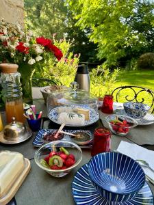 a table with blue and white plates of food on it at la yourte du moulin in Champrond