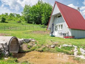 a red and white barn with a red roof at Cottage by the brook in Plužine +17 photos