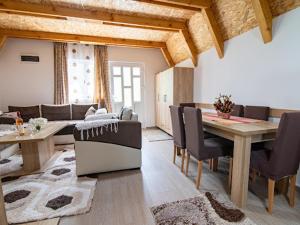 a living room with a dining table and chairs at Cottage by the brook in Plužine