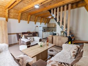 a living room with a couch and a table at Cottage by the brook in Plužine