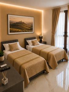 a hotel room with two beds and a painting on the wall at Da Mario in Guarene
