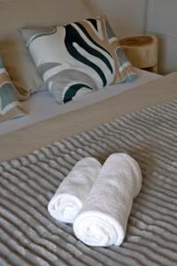 two rolled up towels sitting on a bed at Apartmány LISON in Valtice +35 photos