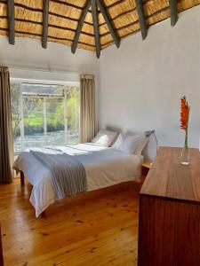a bedroom with a bed and a large window at Forestiva Farm - River Cottage in Centurion +31 photos