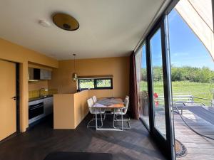 a kitchen and dining room with a table and chairs at Casitas Wijchen - Nijmegen in Wijchen