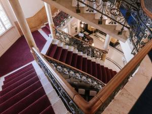 an overhead view of a spiral staircase in a building at Royal St. Georges Hotel Interlaken - MGallery Collection in Interlaken