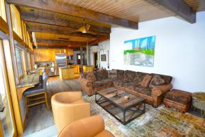 a living room with a couch and a table at Deer Lodge #2- Lake Front in Bass Lake