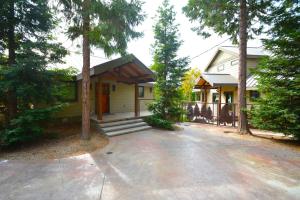 a house with a driveway in front of it at Deer Lodge #2- Lake Front in Bass Lake