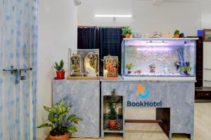 a fish tank sitting on a shelf next to a shelf at Hotel Elguse in kolkata