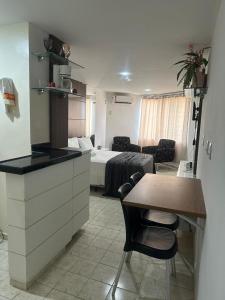 a kitchen and a room with a bed and a table at Hotel Victory flat in Cabedelo