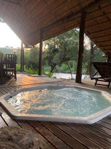 a large hot tub on a wooden deck at Forestiva Farm - River Cottage in Centurion